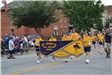 Kids holding banner walking in parade