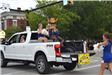 High school mascot sitting in truck in parade