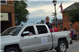 Pork Queen sitting in truck in parade