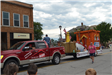 Truck pulling float in parade