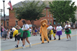 Person dressed up like lion walking in parade