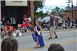 Girl with crown walking in parade