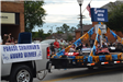 Truck pulling trailer with award winner in parade