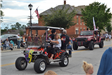 People in vehicles in parade