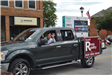 Man waiving from truck in parade