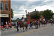 People with horses in parade