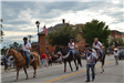 People riding horses in parade