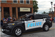 Police Officer waiving from car in parade