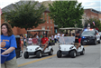 People riding in golf carts in parade