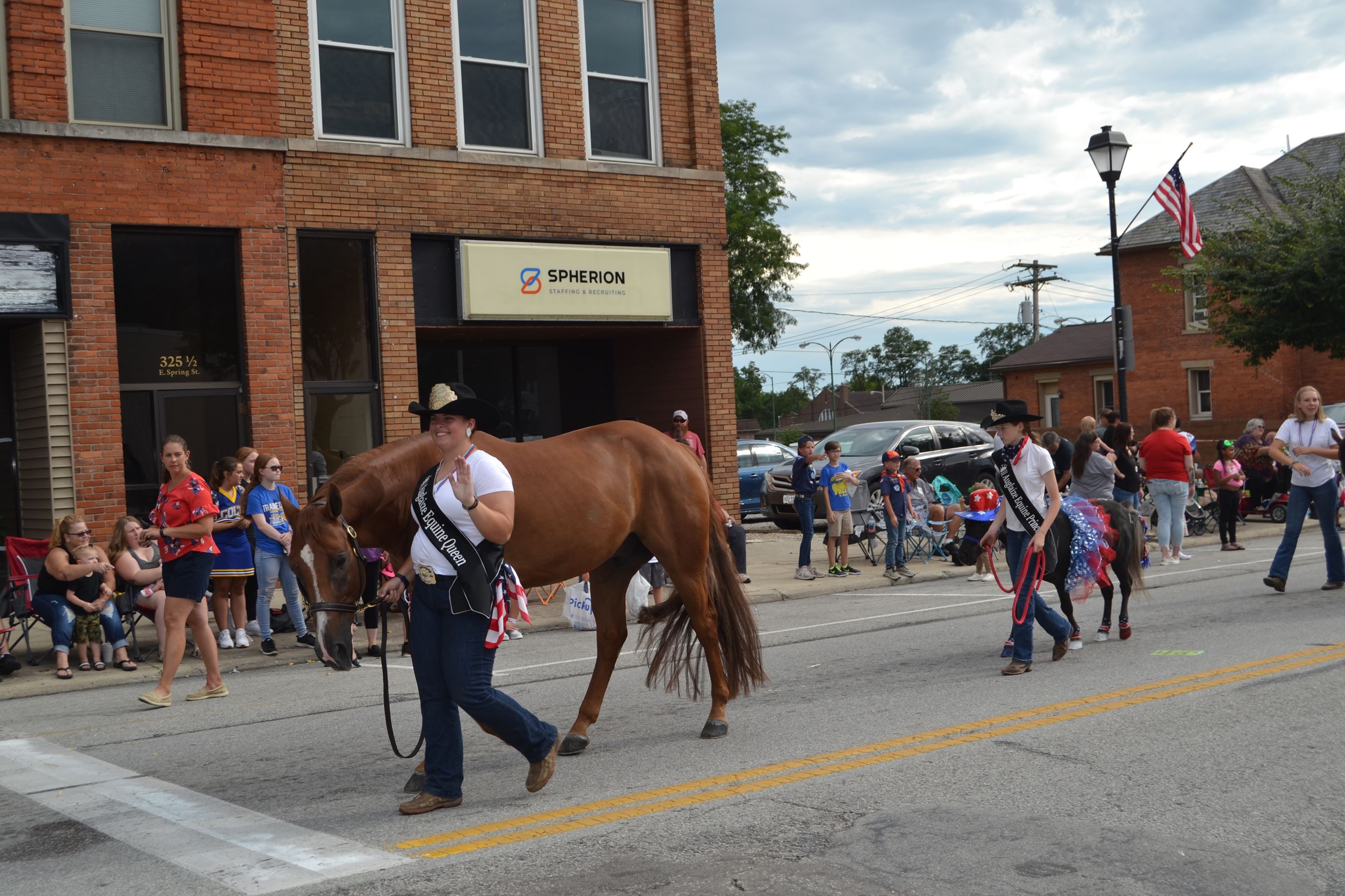 Woman walking horse in parade