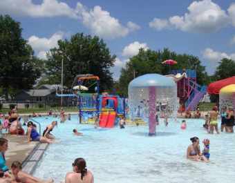 People in Pool with Running Water Umbrella